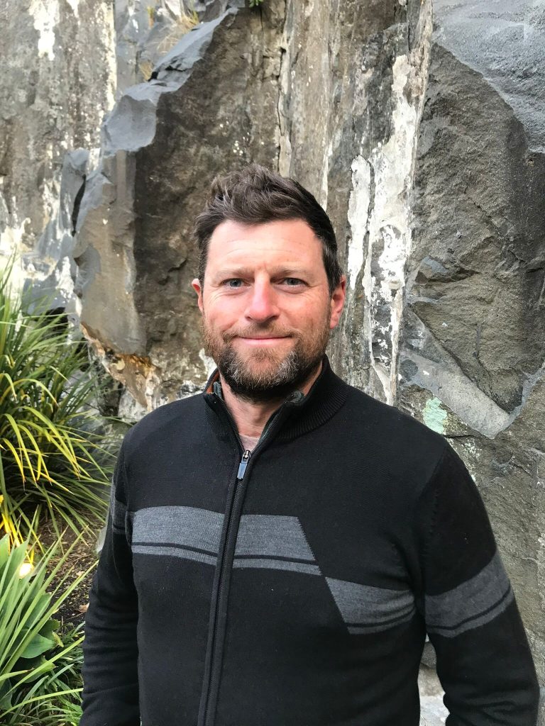 Upper body and face image of Ben Segal against a natural backdrop