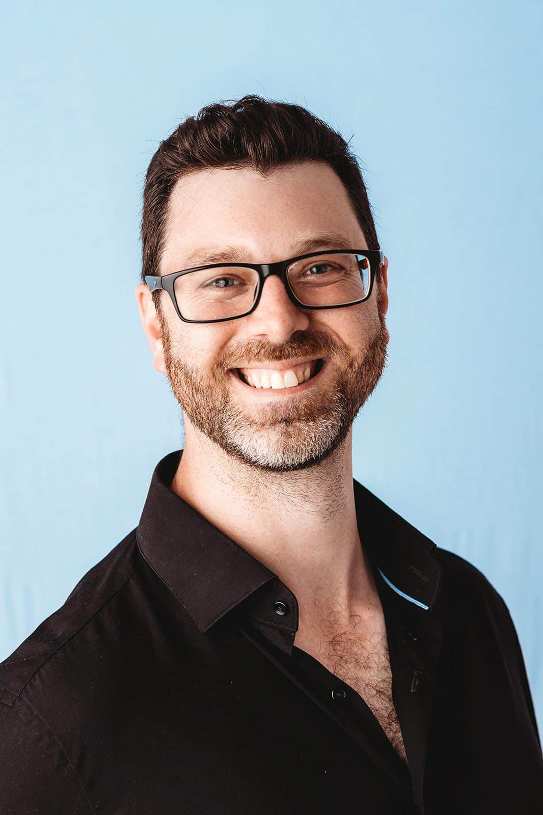 Upper body and face image of Ben Segal against a natural backdrop
